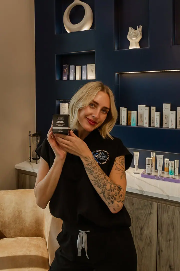 Aesthetic Professional showcasing Medical Grade Skincare Product in a stylish clinic setting