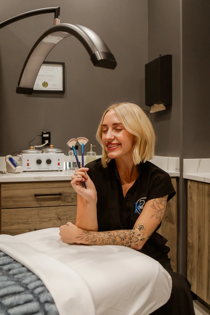 Esthetician with brushes ready for professional facial treatments in a spa