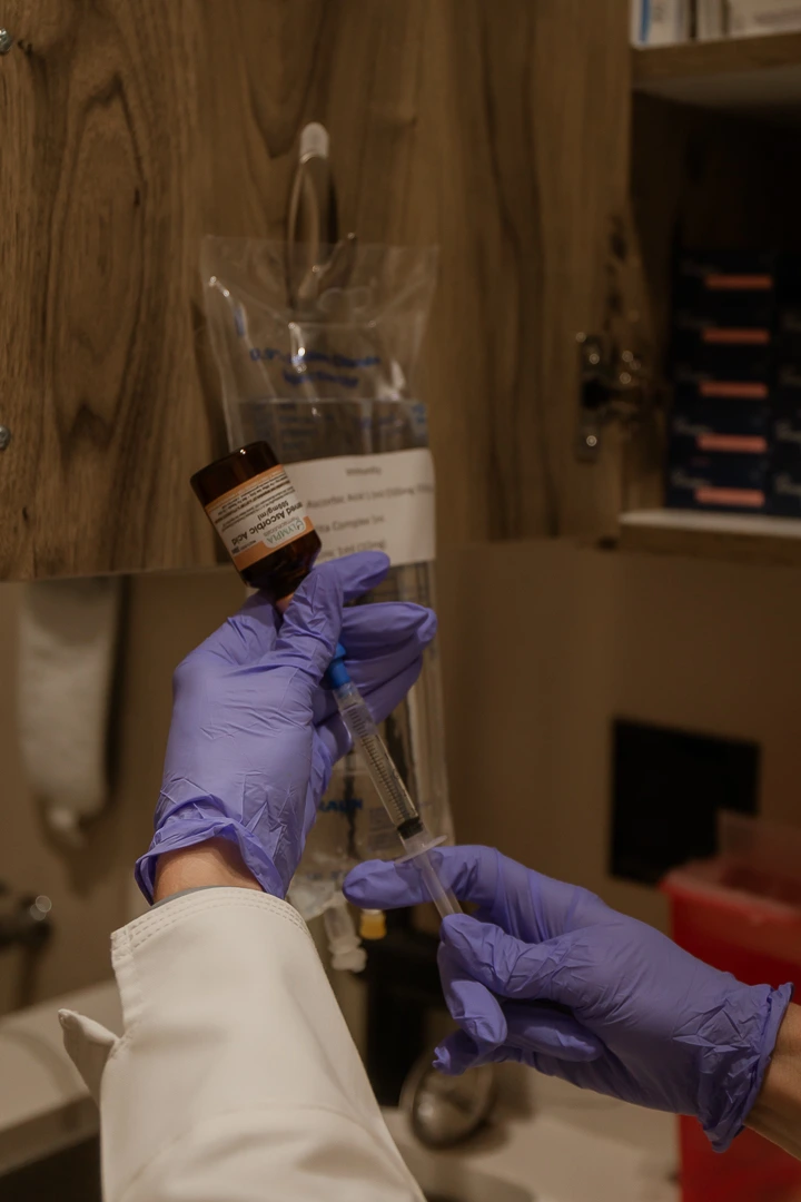 A healthcare professional preparing IV Hydration Therapy injection