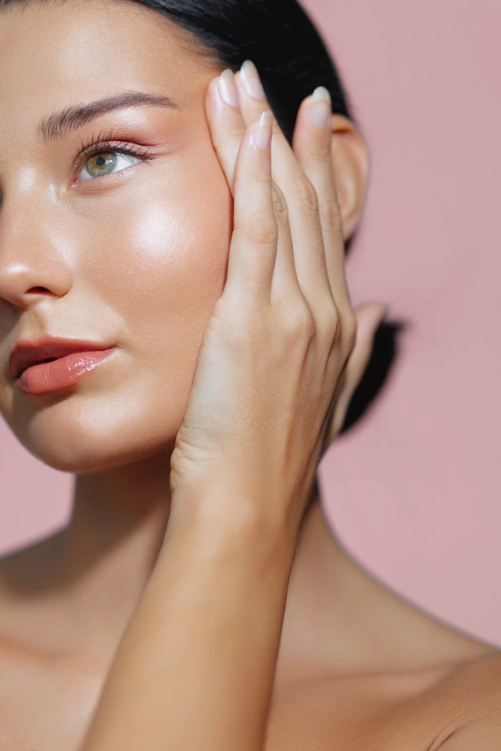 Close-up of a woman with glowing skin, highlighting Sculptra treatment effects