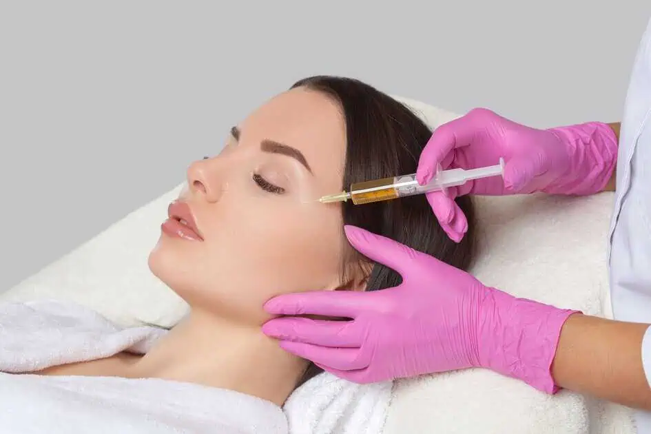 Woman getting dermal filler injections from a healthcare provider