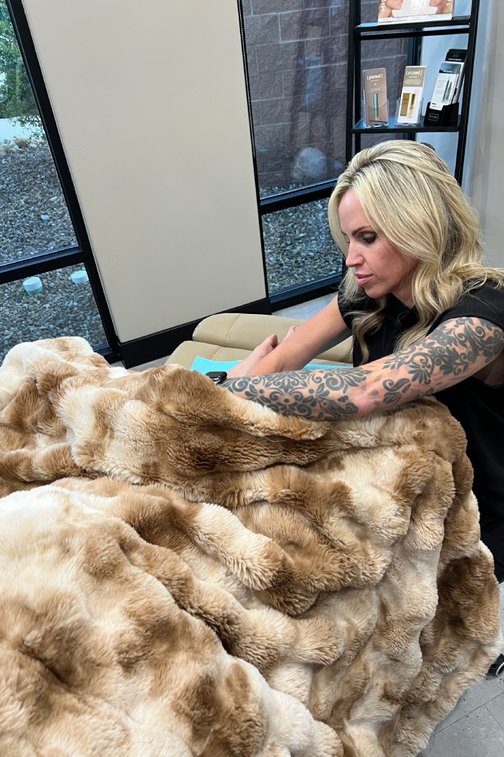 Woman getting WOW Shot under a cozy faux fur blanket by a healthcare provider