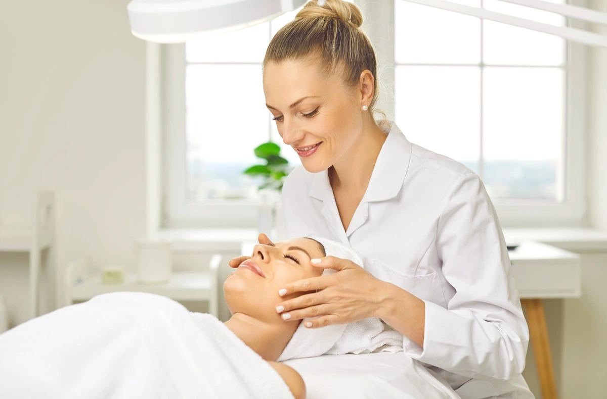 Esthetician performing a facial treatment at a med spa in St. George, Utah.