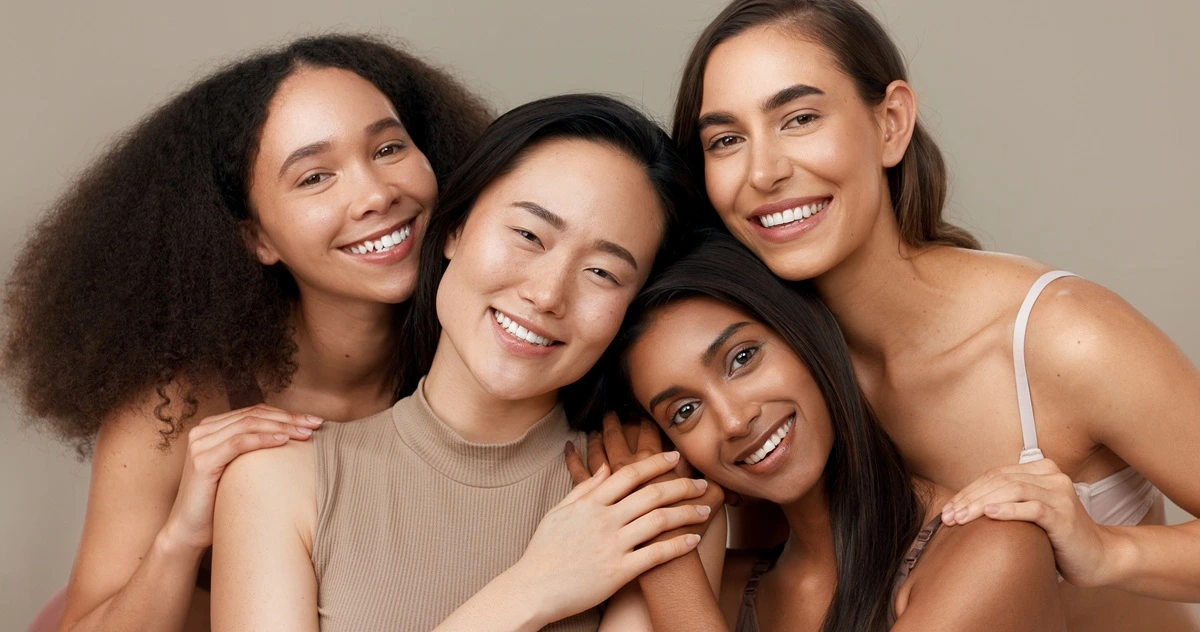 Diverse group of women with different skin tones smiling, representing safe laser and light treatments for all skin types at K2 Aesthetics and Wellness in St. George, UT.