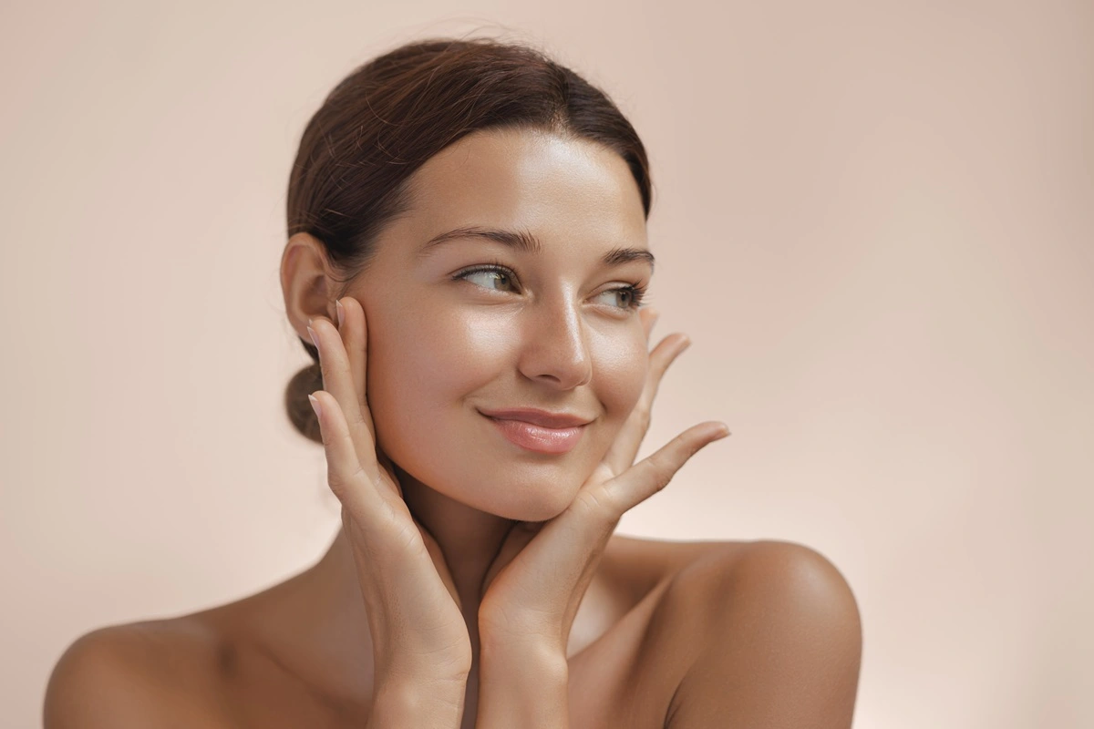 A woman with glowing skin at K2 Aesthetics & Wellness in St. George, UT, after a BBL Heroic treatment.