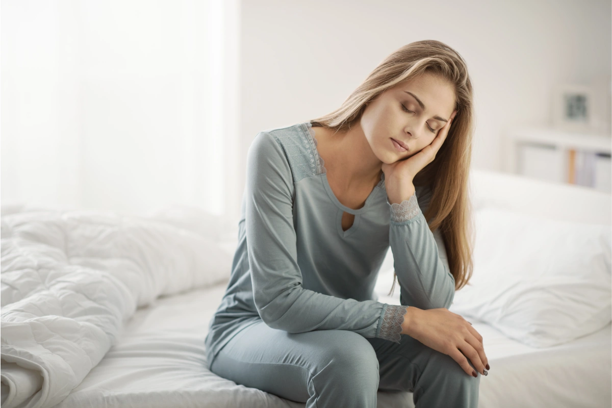 Person experiencing chronic fatigue and low energy while seeking wellness treatments at K2 Aesthetics and Wellness.