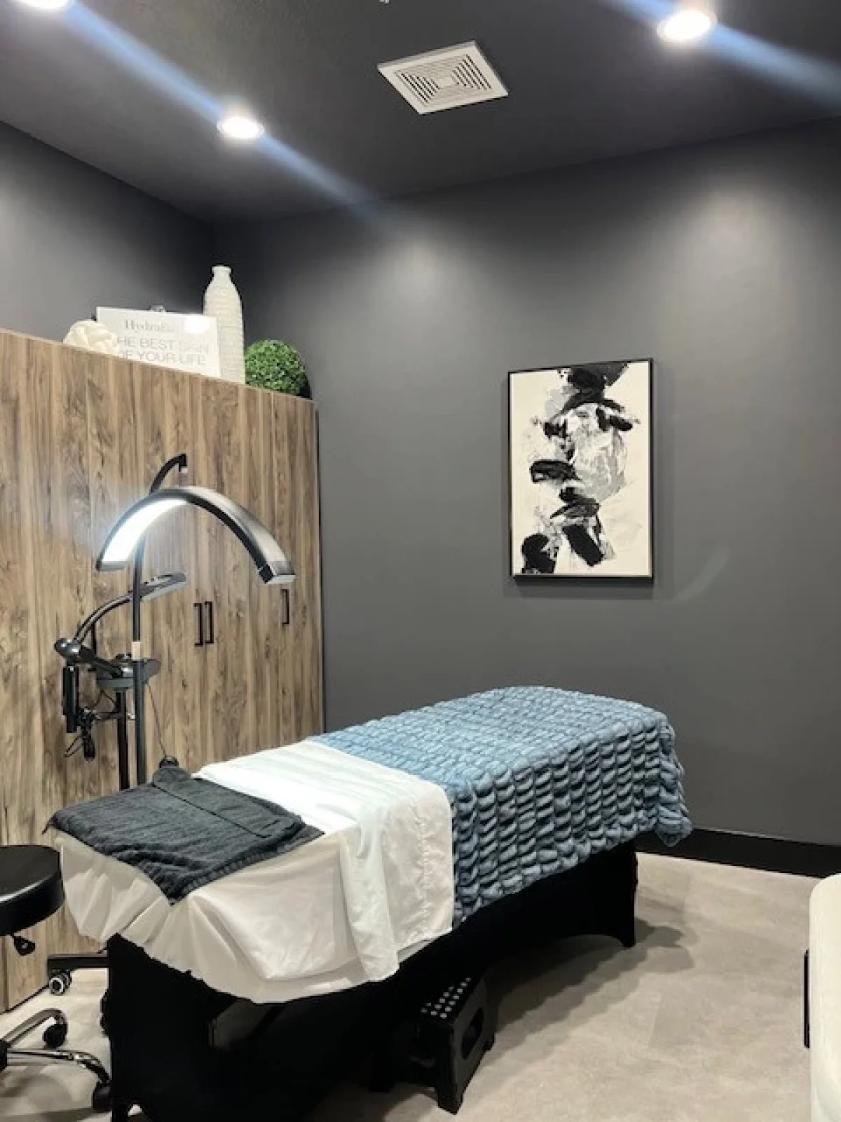 Modern medical spa treatment room with massage table and soft lighting